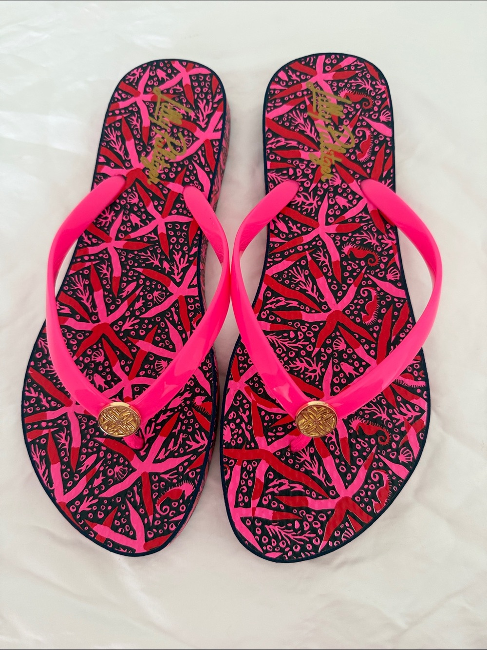 Lilly Pulitzer Hot Pink and Black Patterned Flip Flops with Gold Medallion